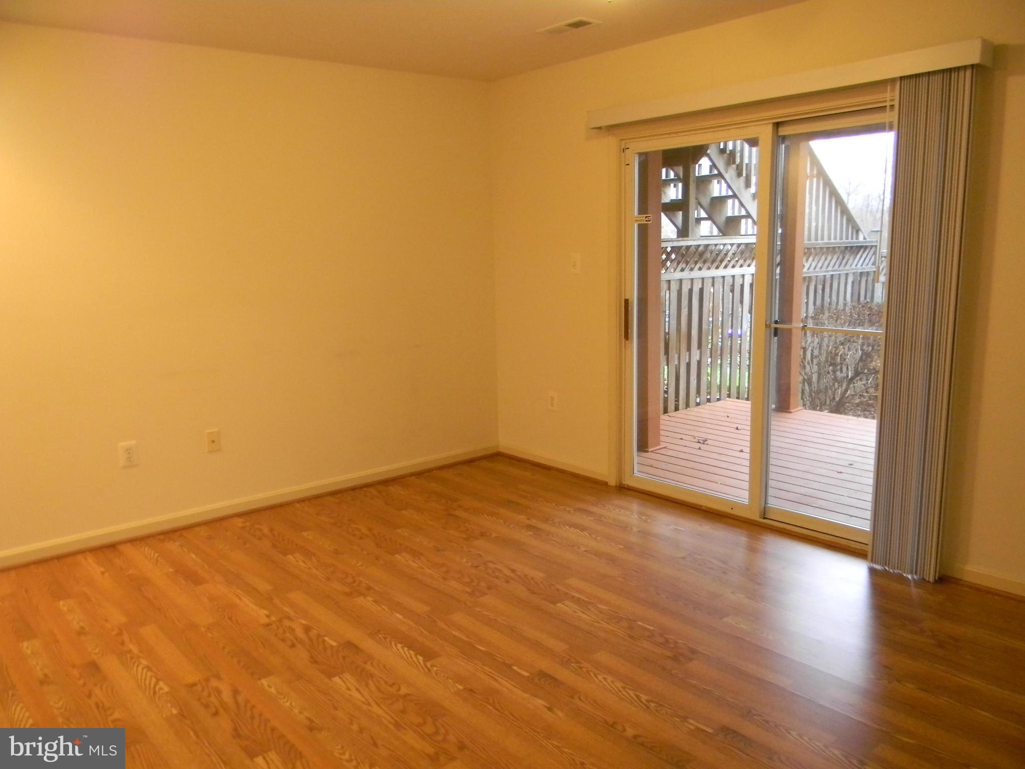 2442 Rippling Brook Road Frederick, MD 21701 - Photo 25 of 30 a view of an empty room with wooden floor and a window