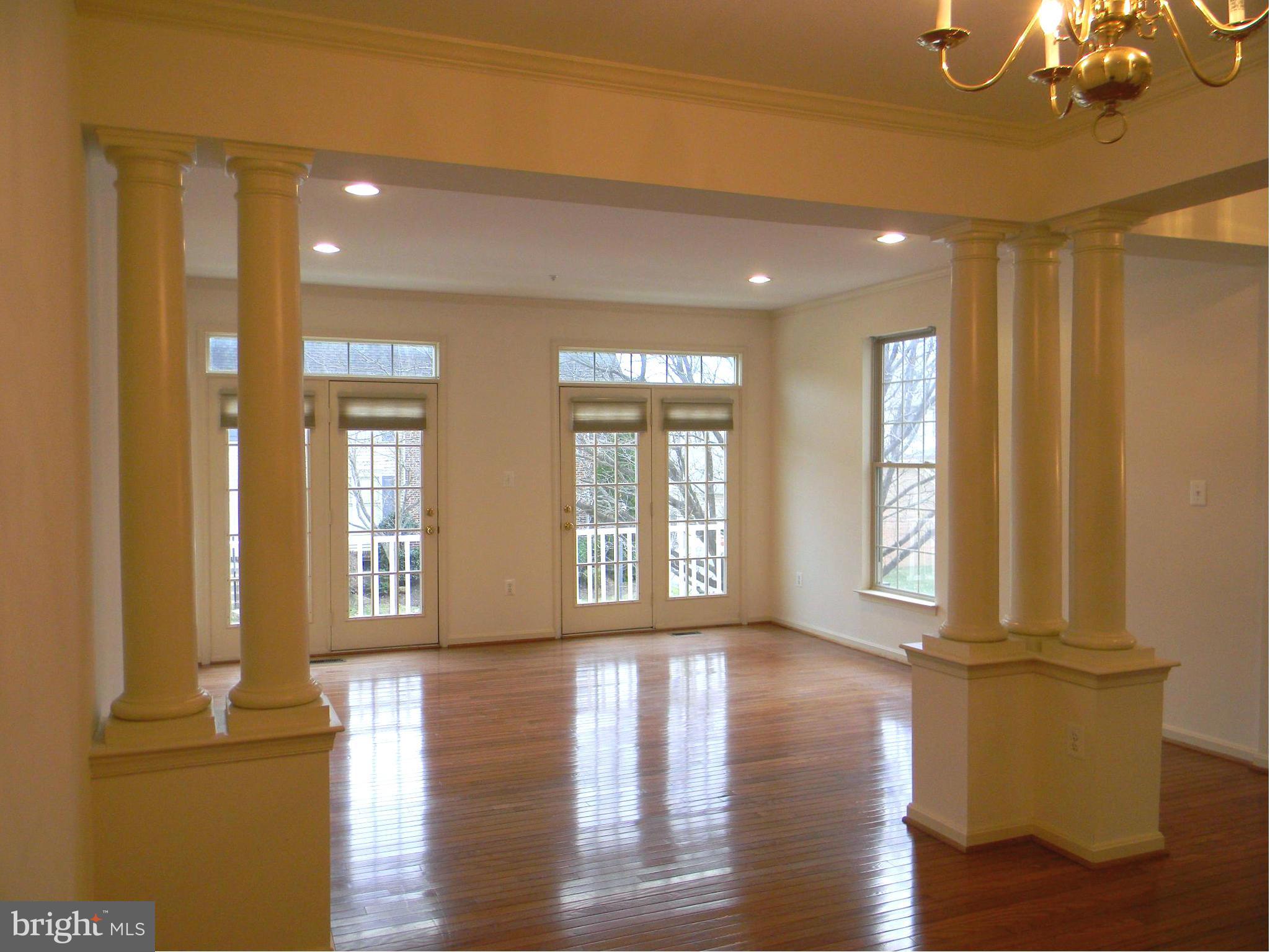2442 Rippling Brook Road Frederick, MD 21701 - Photo 5 of 30 a view of an empty room with wooden floor and a window