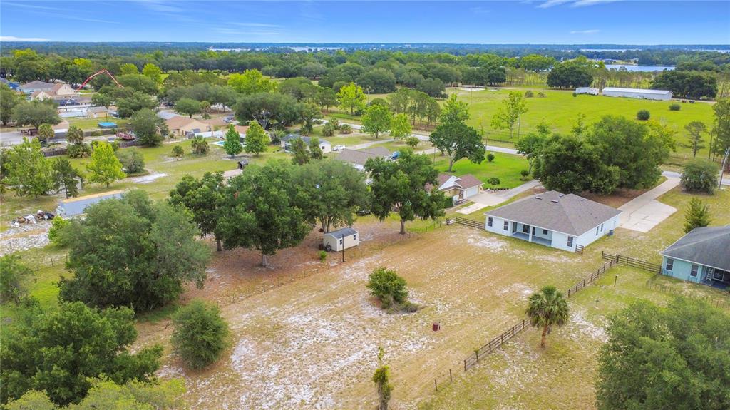 28549 Shirley Shores Road Tavares, FL 32778 - Photo 64 of 65 an aerial view of residential houses with outdoor space and trees