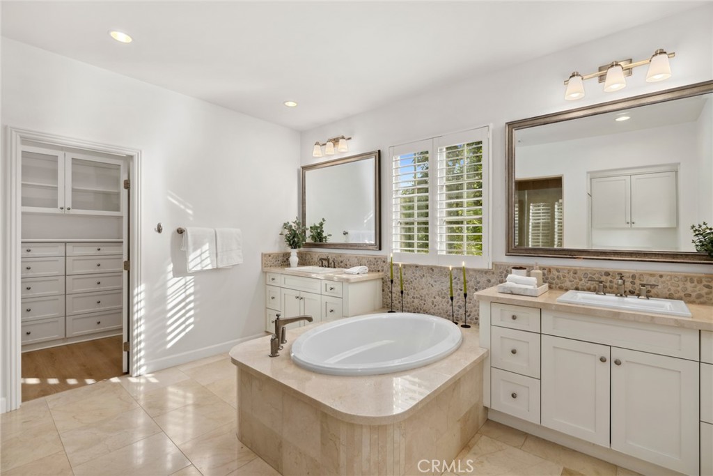70 Livia Irvine, CA 92618 - Photo 21 of 47 Opulent in size and style, the primary suite features a walk-in closet, soaking tub, large shower and separate vanities.