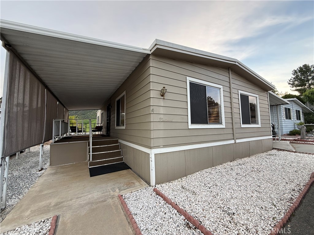 a view of house with entryway and stairs