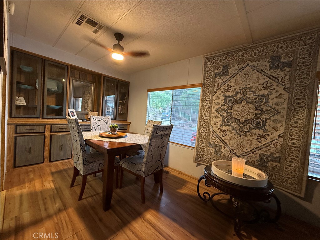 32600 State Highway 74, Unit 140 Hemet, CA 92545 - Photo 8 of 30 a view of a dining room with furniture window and wooden floor