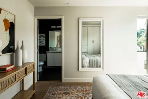 a bedroom with bed and walk in closet