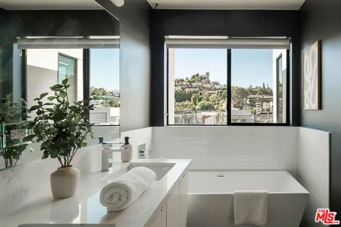 a bath tub sitting in a bathroom next to a window