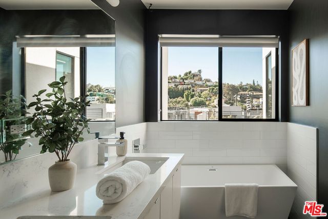 a bath tub sitting in a bathroom next to a window