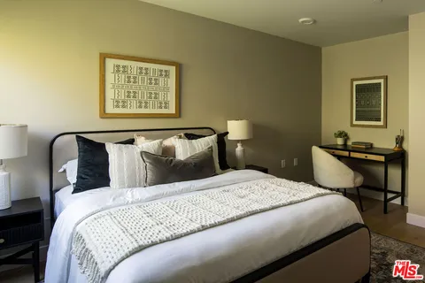 a bedroom with a bed and a table in it