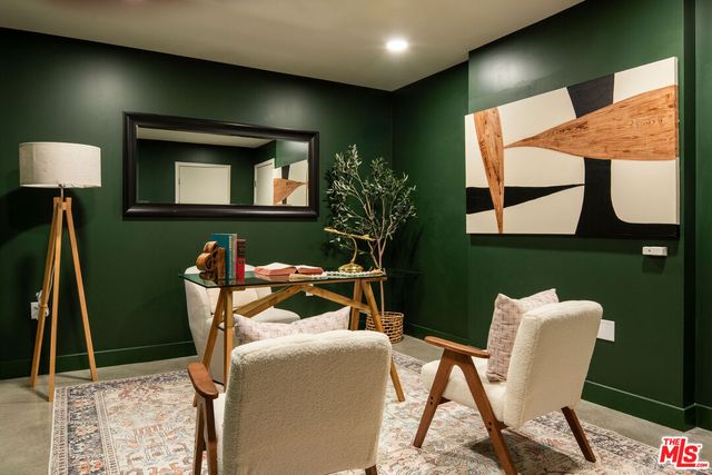 a dining room with furniture and a potted plant