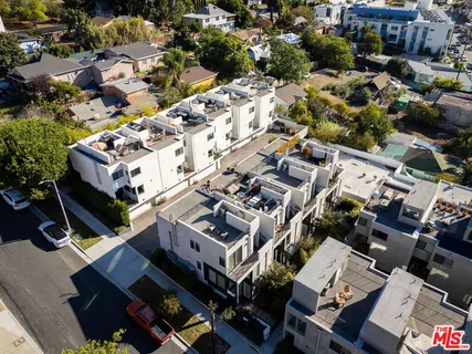 an aerial view of residential houses with yard