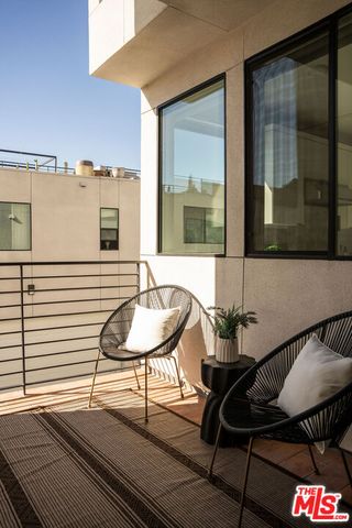 a balcony with table and chairs
