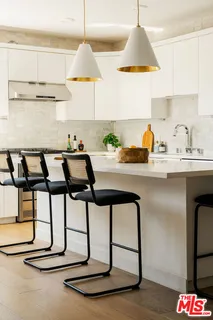 a kitchen with a table and a chair