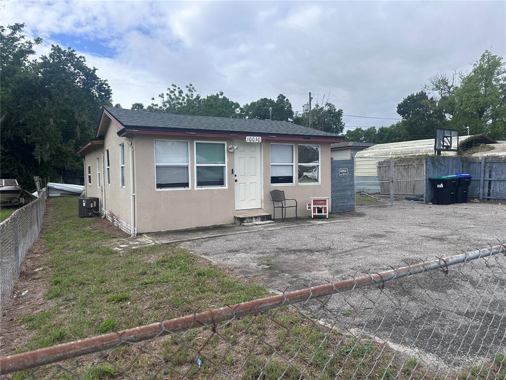 10030 Ingram Avenue Ocoee, FL 34761 - Photo 1 of 16 a view of a house with a yard and a garage