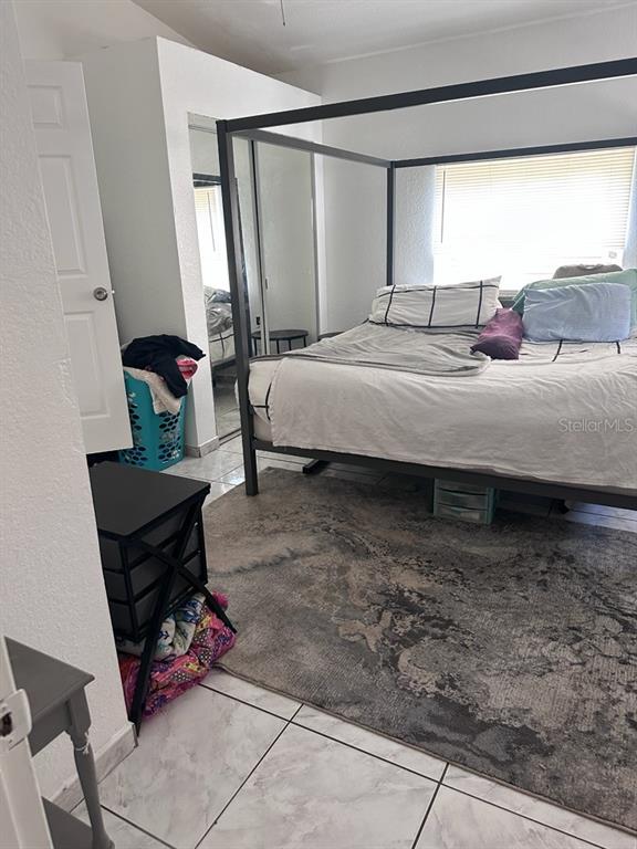 10030 Ingram Avenue Ocoee, FL 34761 - Photo 15 of 16 a bedroom with a bed and a window