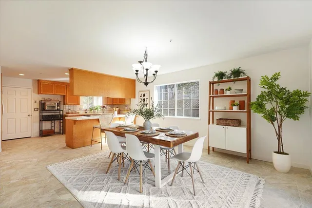 a dining room with furniture and a kitchen