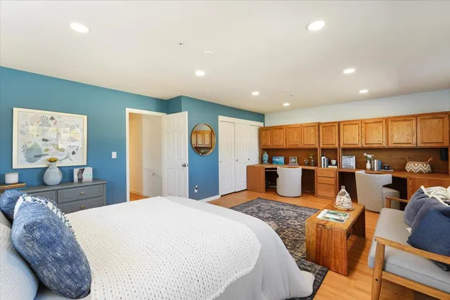 a large bedroom with kitchen island a bed and a large window