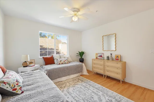 a bedroom with furniture and a large window
