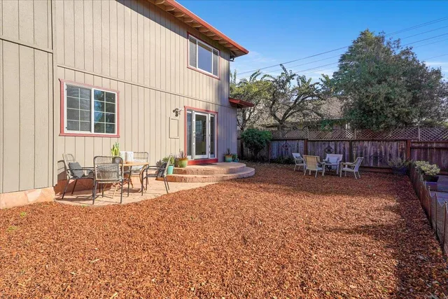 a view of a patio with a table and chairs