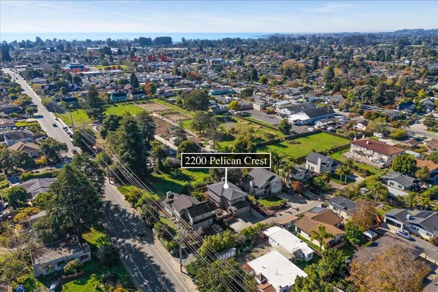 an aerial view of residential house with outdoor space and swimming pool