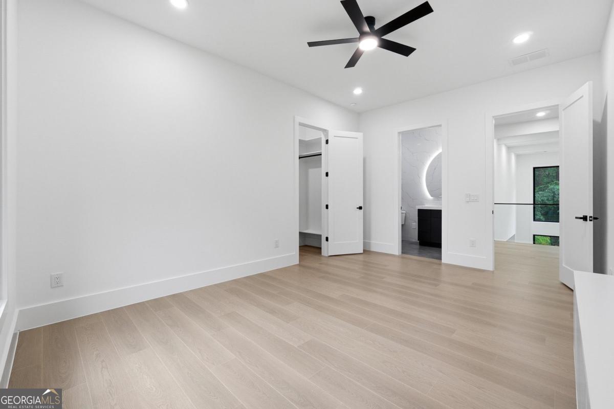 1563 Whitley Road Bethlehem, GA 30620 - Photo 15 of 44 an empty room with wooden floor and a ceiling fan