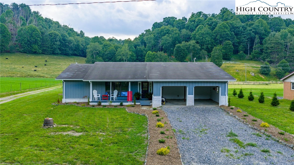 a view of a house with backyard porch and garden