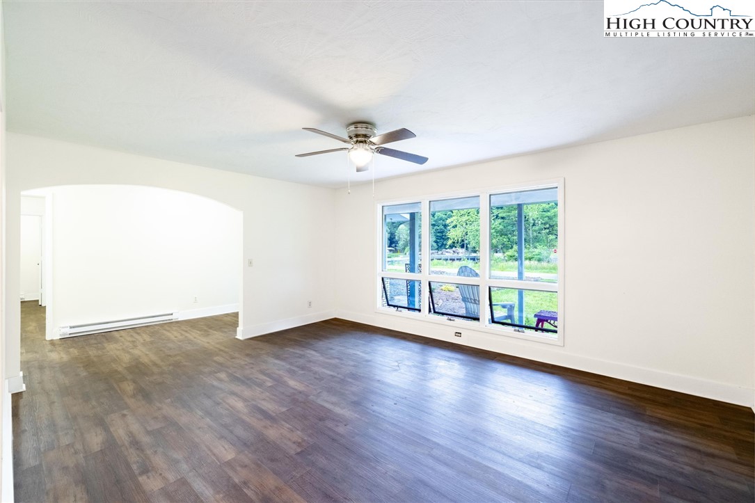 898 3 Top Road Creston, NC 28615 - Photo 12 of 48 a view of an empty room with wooden floor and a window