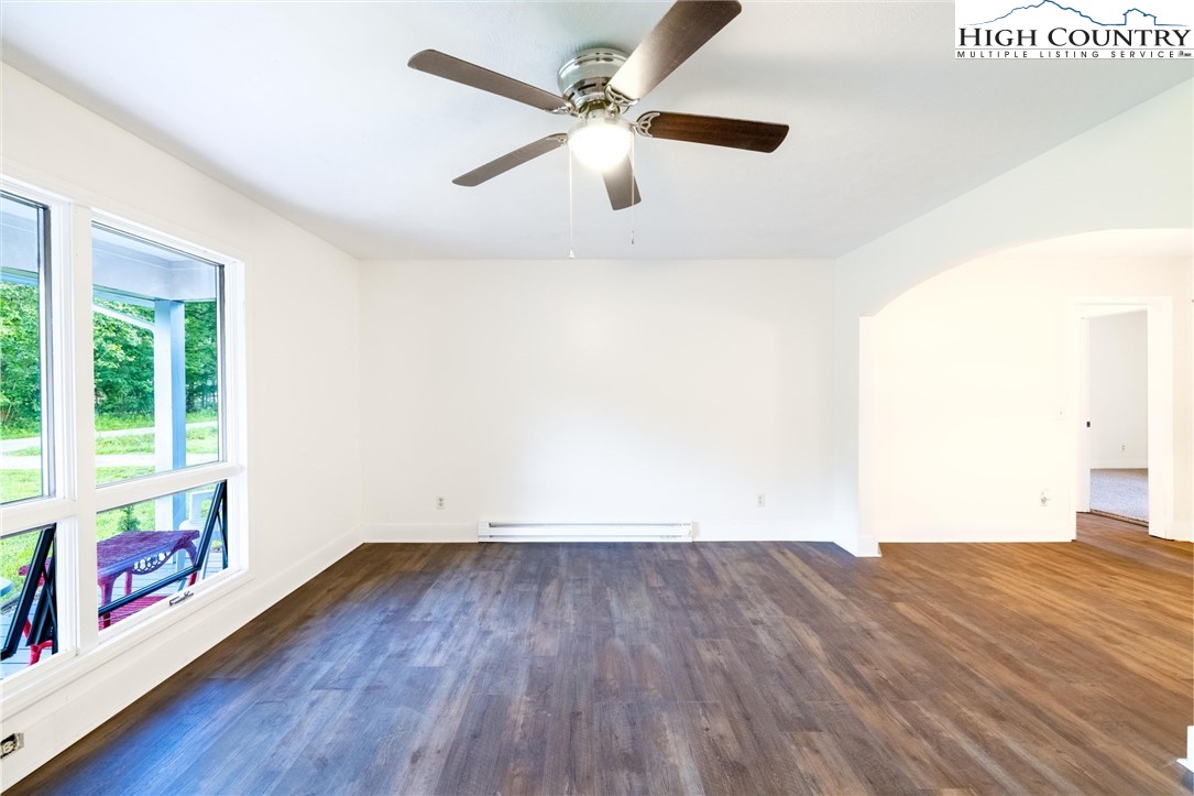 898 3 Top Road Creston, NC 28615 - Photo 13 of 48 wooden floor in an empty room with a window