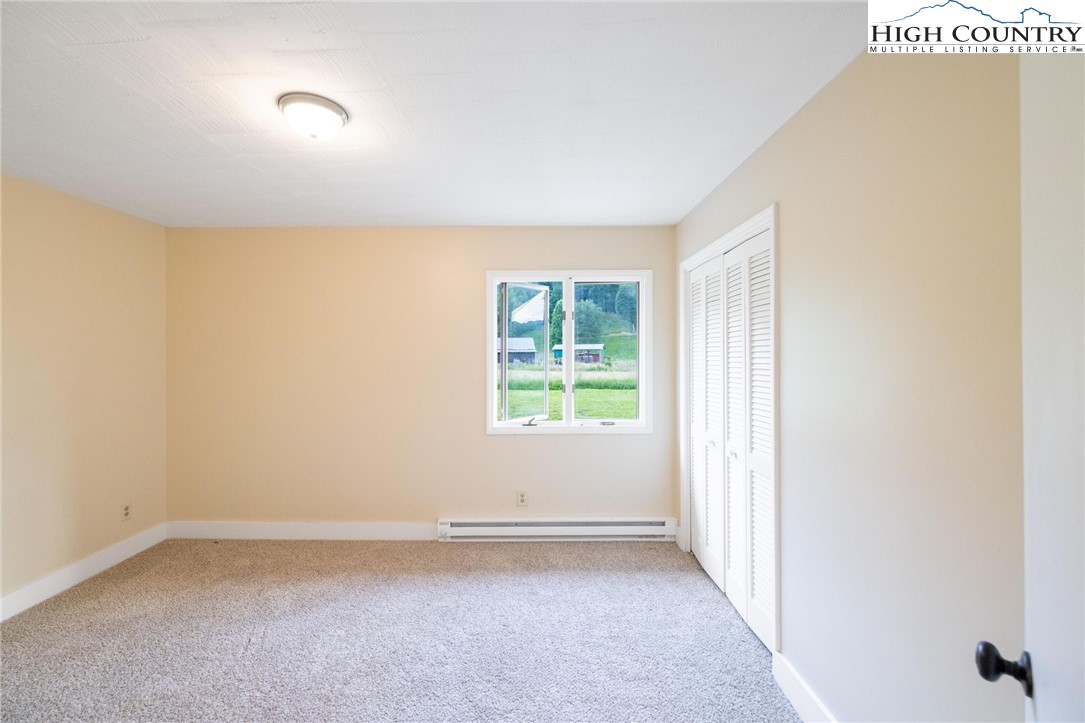 898 3 Top Road Creston, NC 28615 - Photo 15 of 48 an empty room with a empty space and windows
