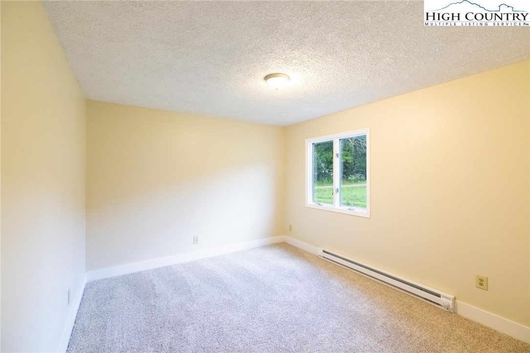 898 3 Top Road Creston, NC 28615 - Photo 17 of 48 a view of an empty room with a window