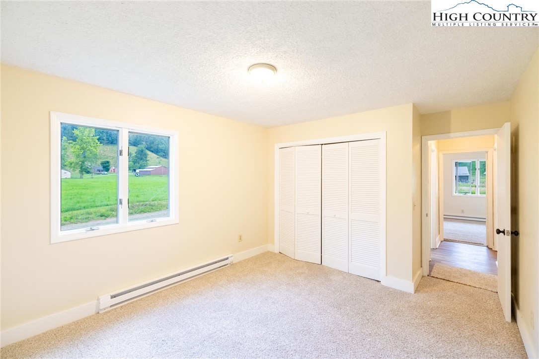 898 3 Top Road Creston, NC 28615 - Photo 18 of 48 a view of an empty room with a window