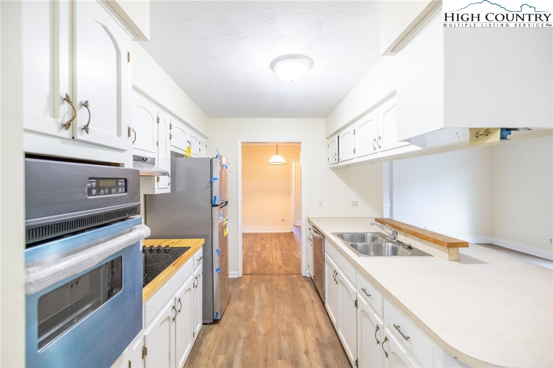 898 3 Top Road Creston, NC 28615 - Photo 23 of 48 a kitchen with a stove and a refrigerator