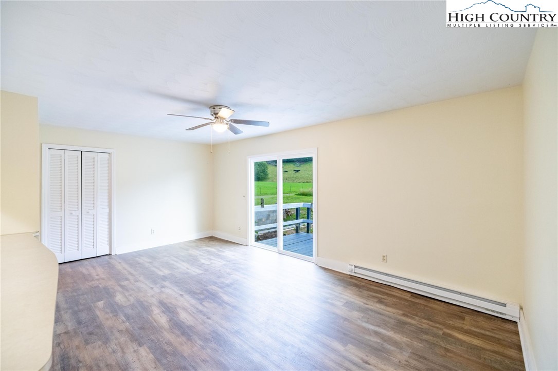 898 3 Top Road Creston, NC 28615 - Photo 24 of 48 an empty room with wooden floor and windows