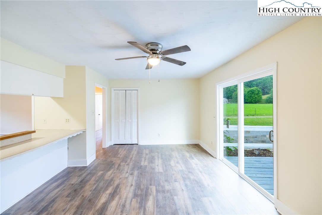 898 3 Top Road Creston, NC 28615 - Photo 25 of 48 a view of a kitchen with wooden floor and a ceiling fan
