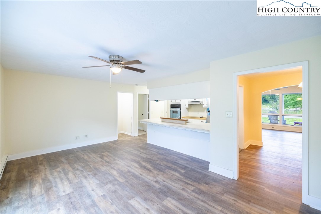 898 3 Top Road Creston, NC 28615 - Photo 29 of 48 a view of a kitchen with wooden floor and a ceiling fan