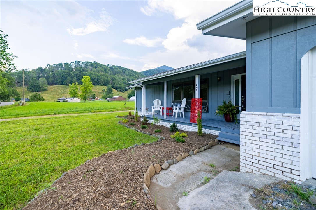 898 3 Top Road Creston, NC 28615 - Photo 3 of 48 a view of a porch with furniture and a yard