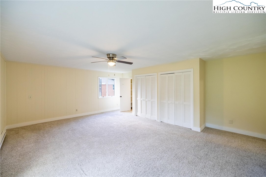898 3 Top Road Creston, NC 28615 - Photo 31 of 48 an empty room with windows and fan