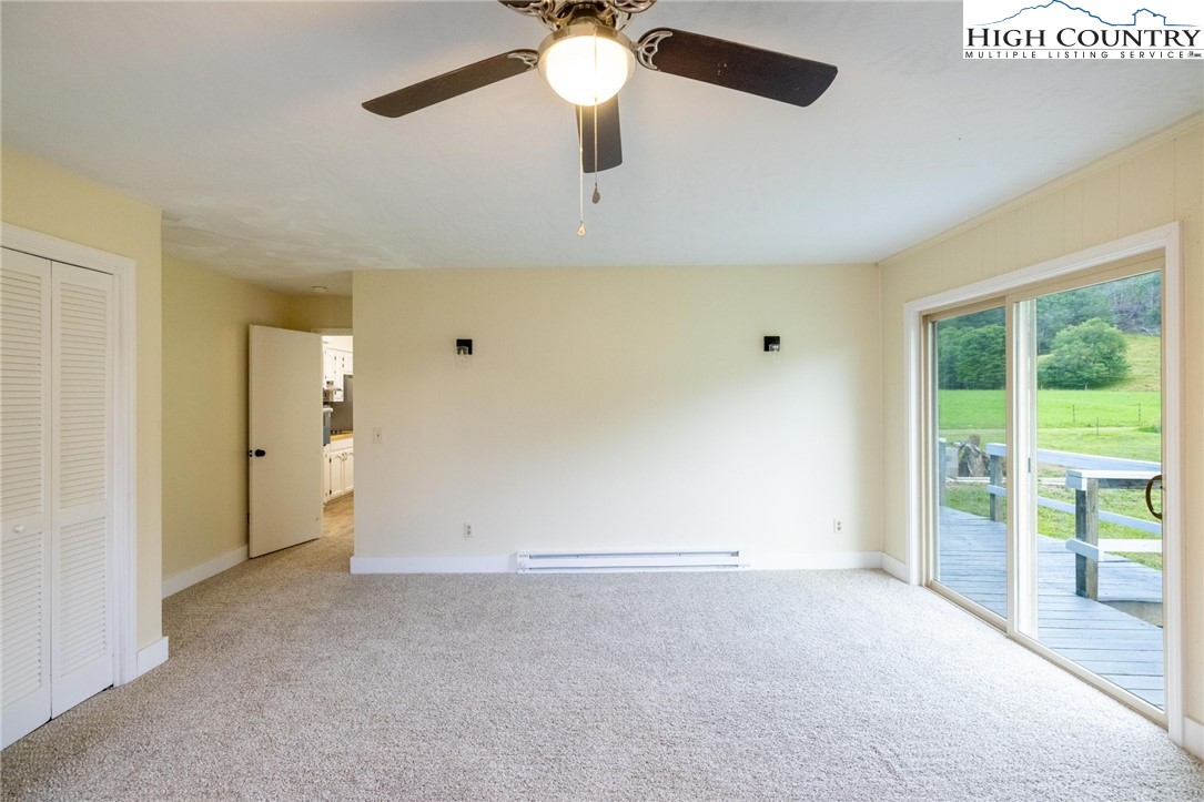 898 3 Top Road Creston, NC 28615 - Photo 35 of 48 an empty room with chandelier fan and windows