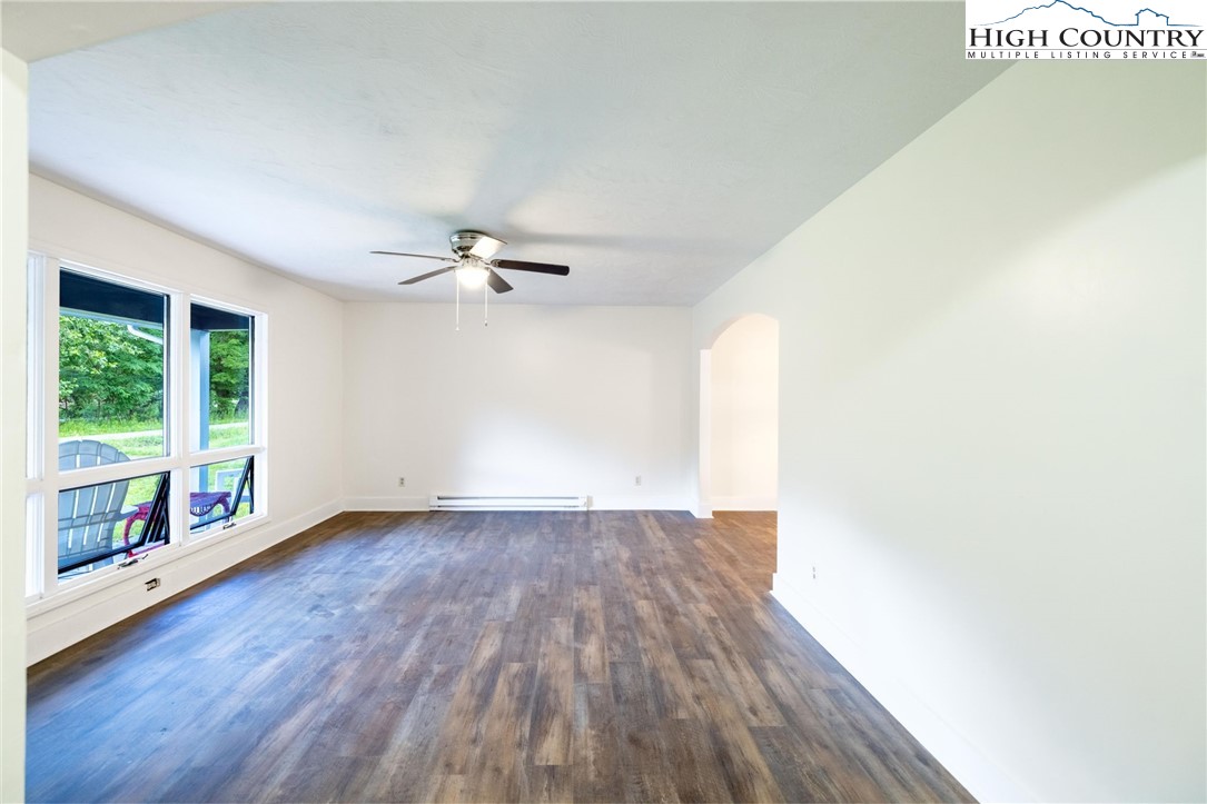 898 3 Top Road Creston, NC 28615 - Photo 10 of 48 a view of an empty room with wooden floor and a window