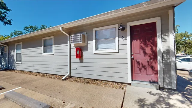 a view of a house with a door and small yard