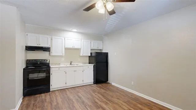 a kitchen with granite countertop cabinets and steel stainless steel appliances