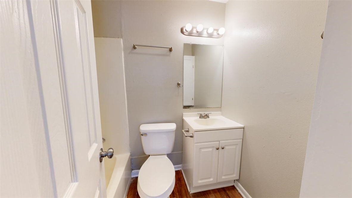 500 Foch Street, Unit 4 Bryan, TX 77801 - Photo 9 of 12 a bathroom with a toilet sink and mirror