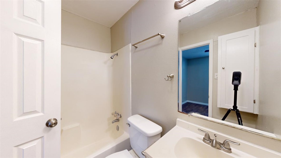 500 Foch Street, Unit 4 Bryan, TX 77801 - Photo 10 of 12 a bathroom with a granite countertop sink toilet and shower