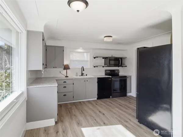 a kitchen with white cabinets and stainless steel appliances