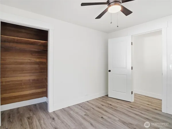 a view of empty room with wooden floor