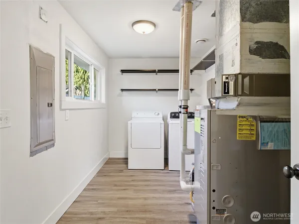 a view of a hallway with wooden floor and entryway