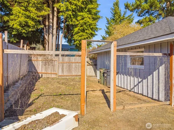 a view of a large trees with wooden fence