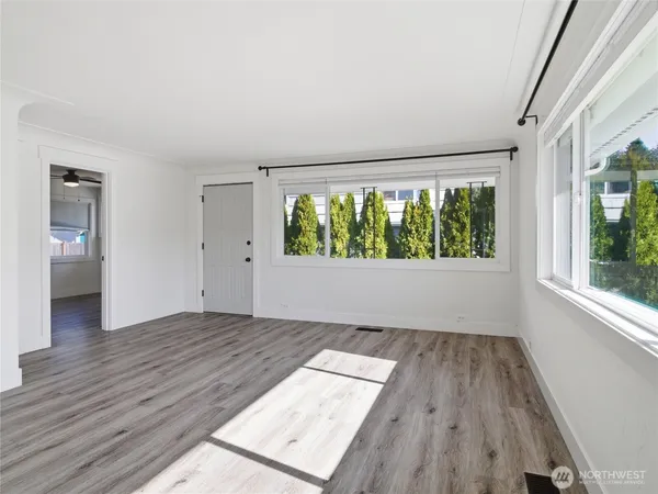 wooden floor in an empty room with a window