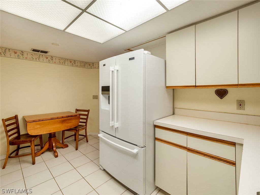 13166 Heather Ridge Loop Fort Myers, FL 33966 - Photo 12 of 31 a white refrigerator freezer and a stove sitting inside of a kitchen
