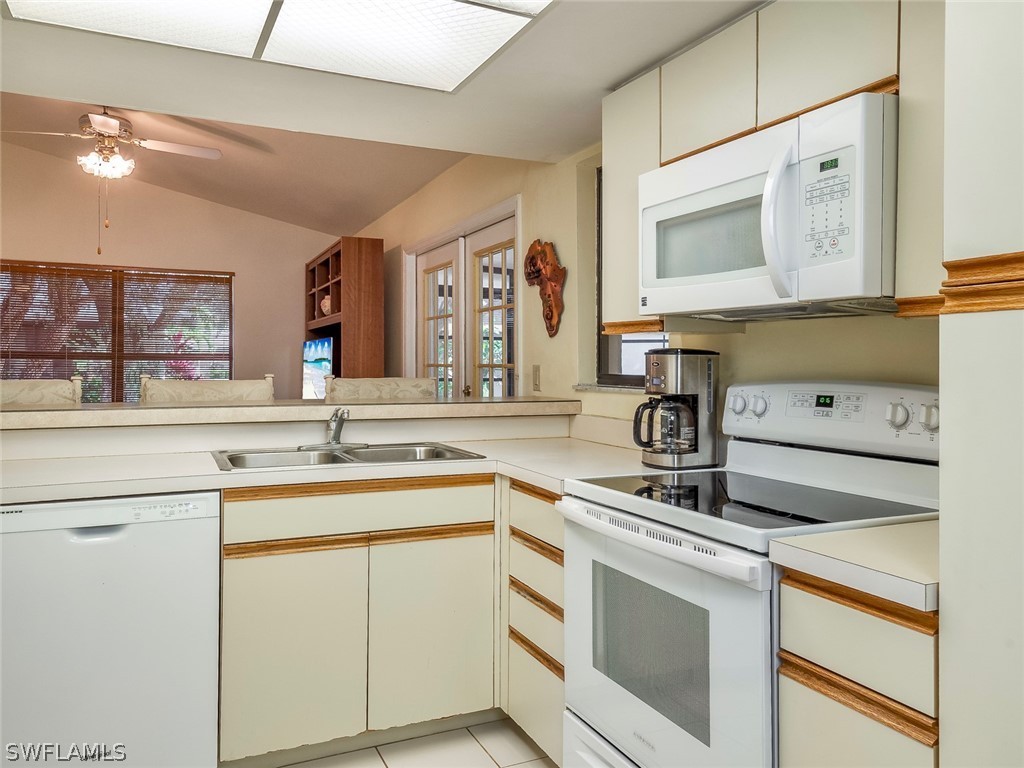 13166 Heather Ridge Loop Fort Myers, FL 33966 - Photo 10 of 31 a kitchen with a sink stove and microwave