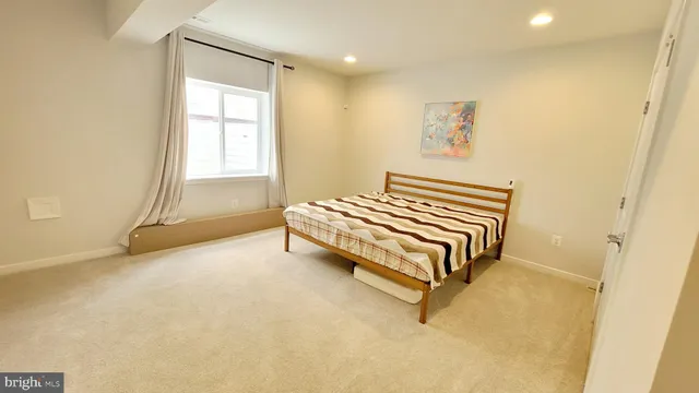 a large room with a bed and a chandelier