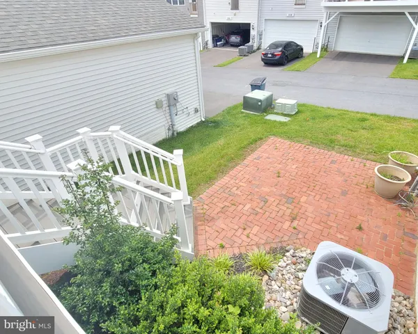 a kitchen with white cabinets stainless steel appliances and kitchen island