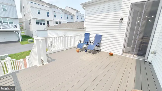 a kitchen with stainless steel appliances granite countertop a table chairs stove and white cabinets